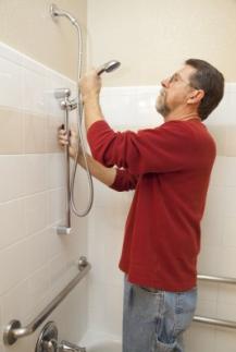 contractor adjusts a shower head